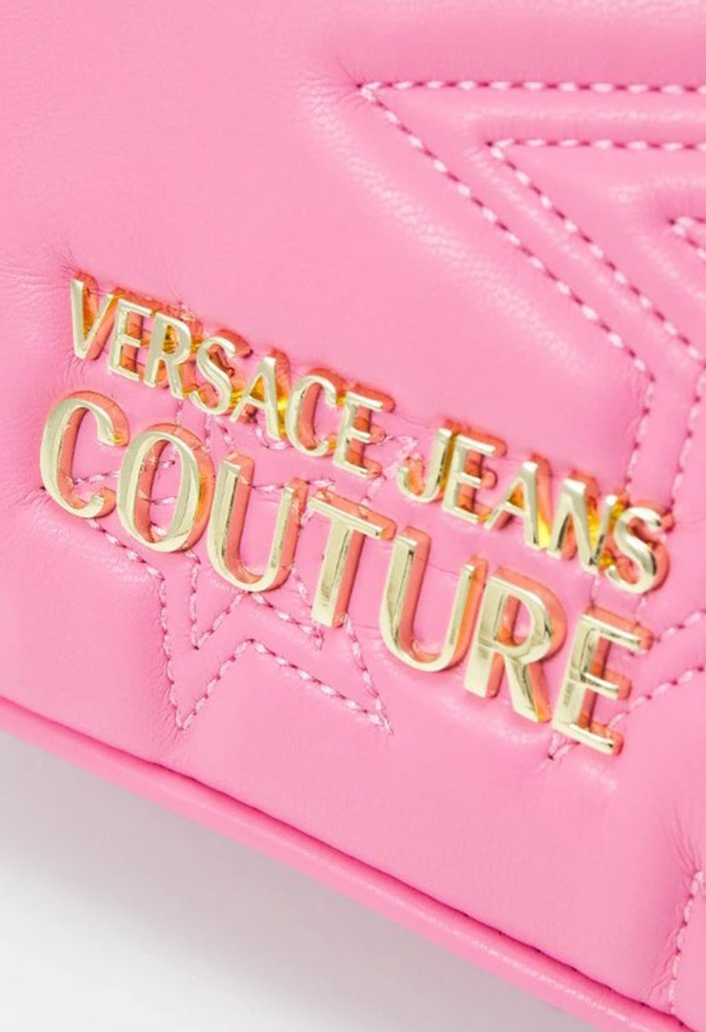 Close-up of the Versace Jeans Couture gold logo on the pink crossbody bag.